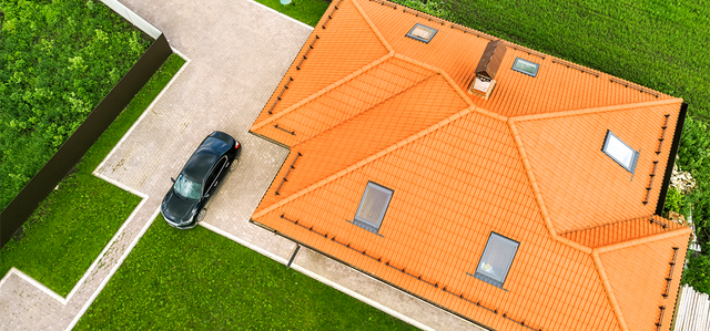 aerial-top-view-house-shingle-roof-with-attic-windows-black-car-paved-yard-with-green-grass-lawn-640w